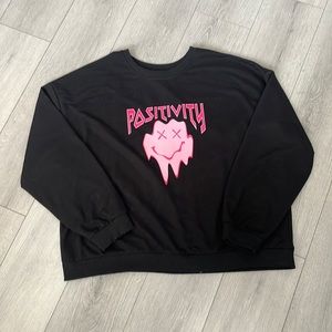Black sweater with pink positivity smiley face